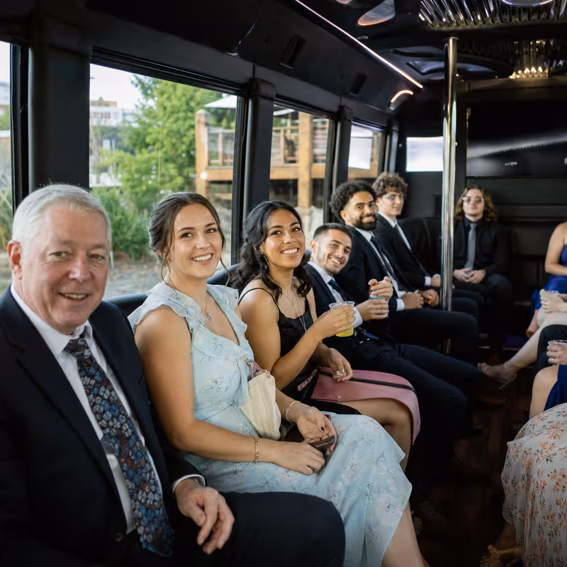 Wedding guests seated inside a Spokane party bus