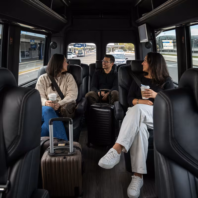 Passengers loading luggage while boarding an Spokane group shuttle