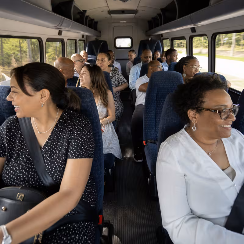 Group boarding a white charter bus for Private Event Transportation transportation in Spokane