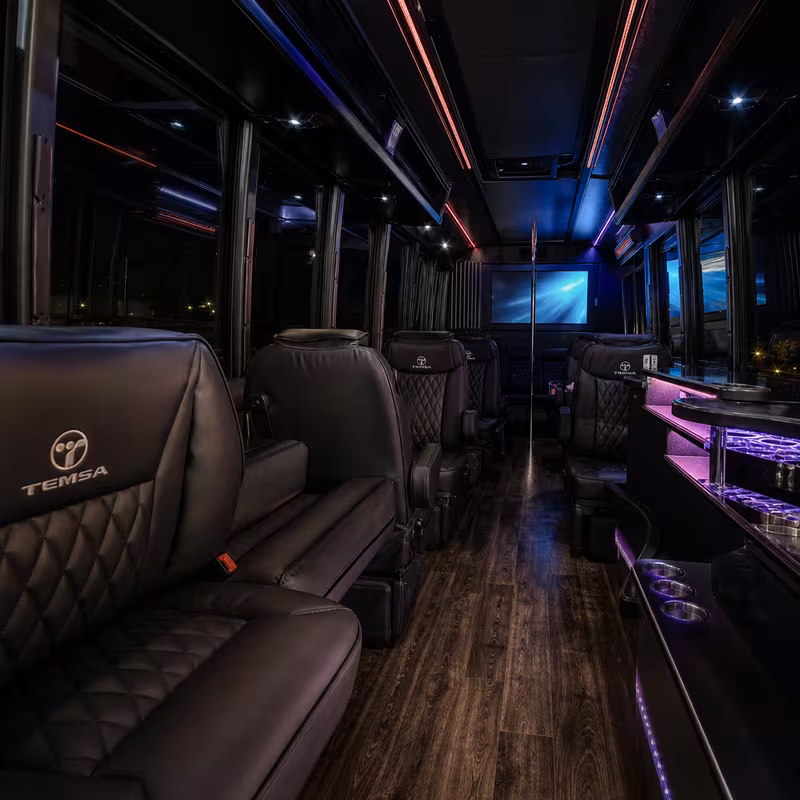 Party bus interior with wraparound leather seating and LED lighting in Spokane