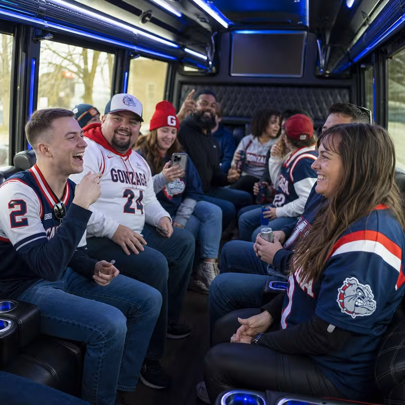 Group boarding a white charter bus for Sporting Event Transportation transportation in Spokane