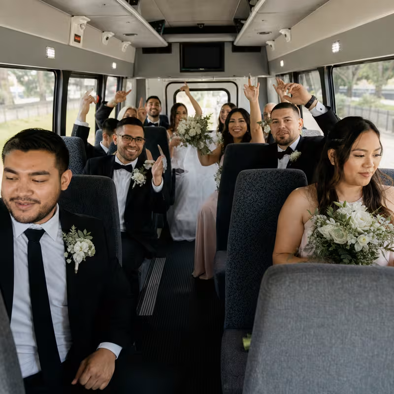 Group boarding a white charter bus for Wedding Transportation transportation in Spokane