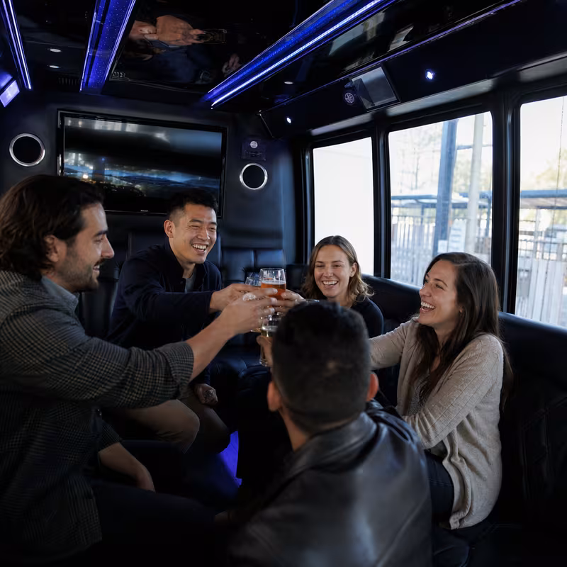 Group boarding a white charter bus for Winery & Brewery Tour Transportation transportation in Spokane